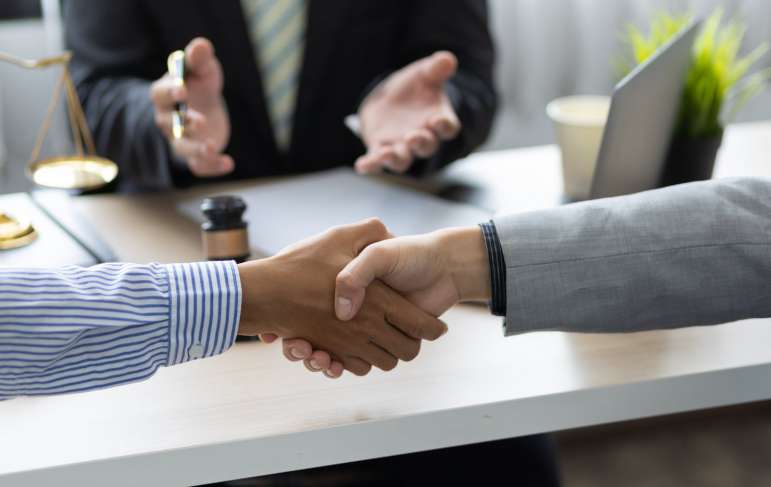 Two people shaking hands.