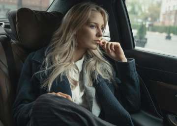 A woman sitting in the backseat of a car.