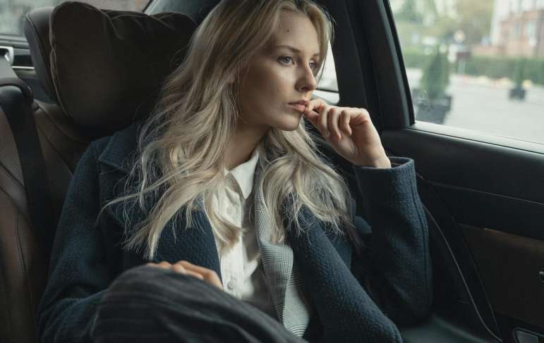 A woman sitting in the backseat of a car.