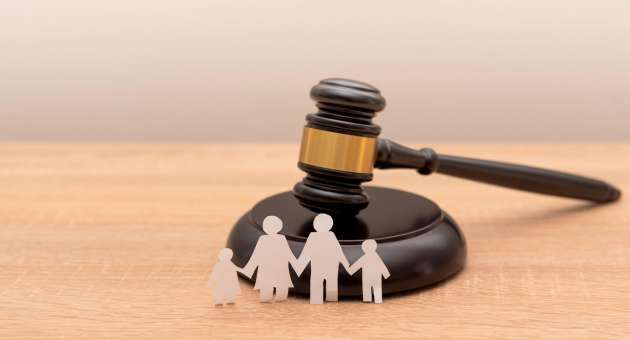 Paper family cutout with a gavel.